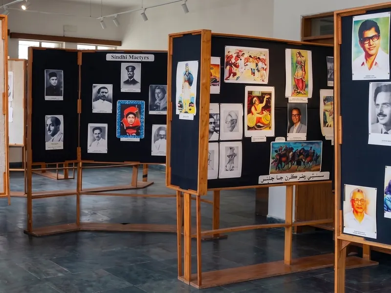 Display boards in the Institute&rsquo;s gallery, hung with portraits and paintings