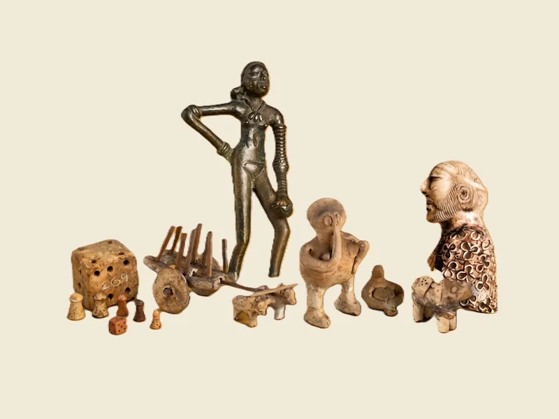 Terracotta figures, a toy bullock cart, dice and gaming pieces from the collection