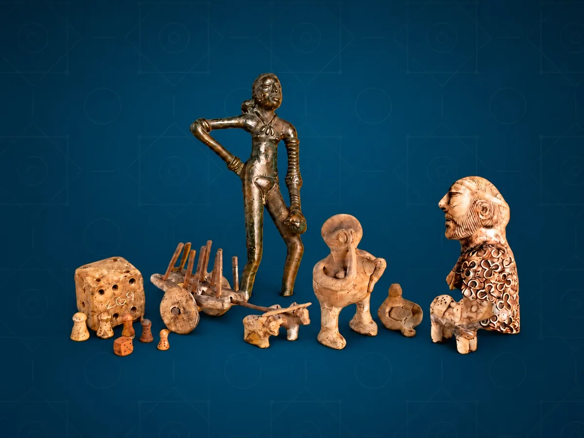 Terracotta figures, a toy bullock cart, dice and gaming pieces from the collection